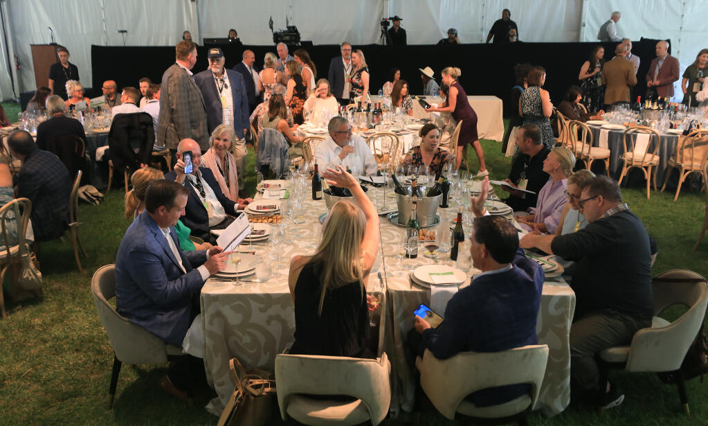Sonoma County Wine Auction attendees take their seats in preparation for the auction, held at La Crema Estate at Saralee’s Vineyard in Windsor,  Saturday, Sept. 16, 2023. (Kent Porter / The Press Democrat file)