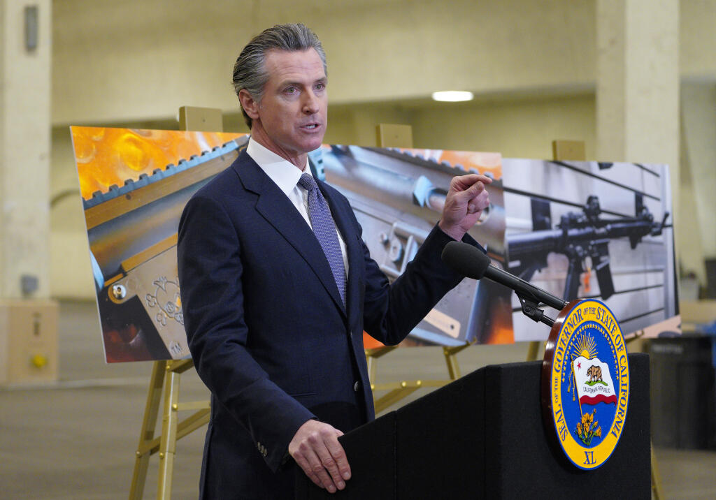 FILE - California Gov. Gavin Newsom speaks to reporters at Del Mar Fairgrounds on Feb. 18, 2022, in Del Mar, Calif. On Friday, Dec. 16, 2022, U.S. District Judge Roger T. Benitez said he will issue an injunction to block part of a new state law that critics say would make it nearly impossible to challenge the state's gun laws in court. Newsom has championed the law and defended it in court. (Nelvin C. Cepeda/The San Diego Union-Tribune via AP, File)