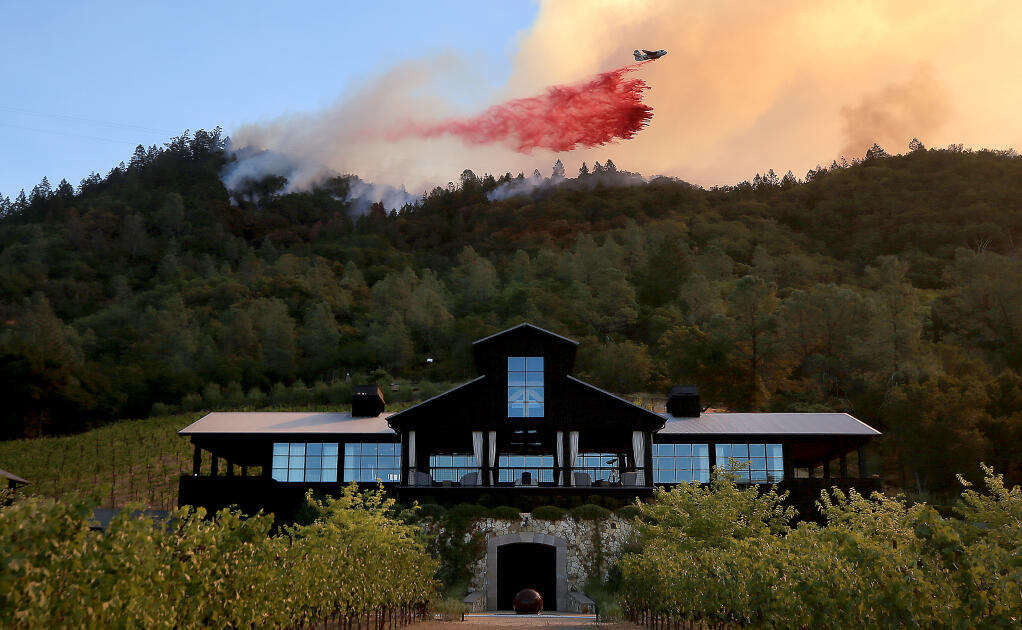A tanker drops above Davis Winery on Silverado Trail during the Glass fire, Sunday, Sept. 27, 2020 near St. Helena. (Kent Porter / The Press Democrat)