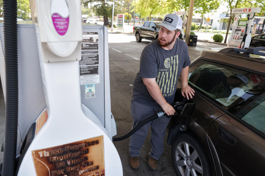Nate Johnson puts gas in his car at the Safeway station along Mendocino Avenue in Santa Rosa on Tuesday, May 23, 2023.  (Christopher Chung/The Press Democrat)
