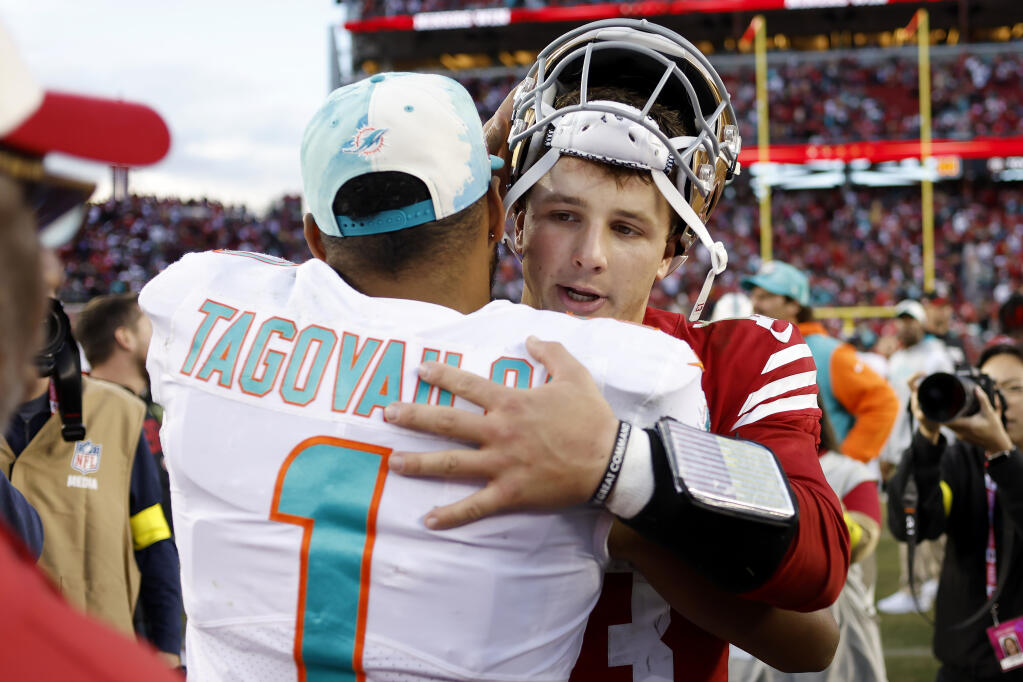 49ers quarterback Brock Purdy hugs Miami Dolphins quarterback Tua Tagovailoa after Sunday’s game in Santa Clara. (Jed Jacobsohn / ASSOCIATED PRESS)
