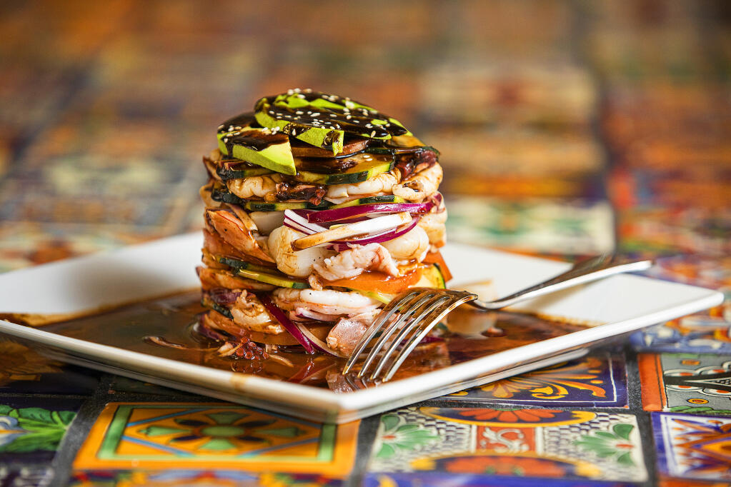 Torre de Mariscos is a tower of seafood, onion, avocado and cucumber from Pezcow in Windsor on Friday, April 1, 2022. (John Burgess/The Press Democrat)
