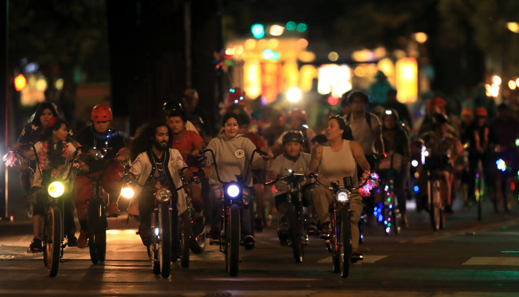 The Taco Tuesday bike ride rolls down Fourth Street in Santa Rosa on May 31. (KENT PORTER / The Press Democrat)