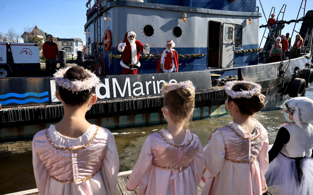 Santa and Mrs. Claus arrive by tugboat on the Petaluma River, Saturday, Nov. 27, 2021 in Petaluma.  (Kent Porter / The Press Democrat) 2021