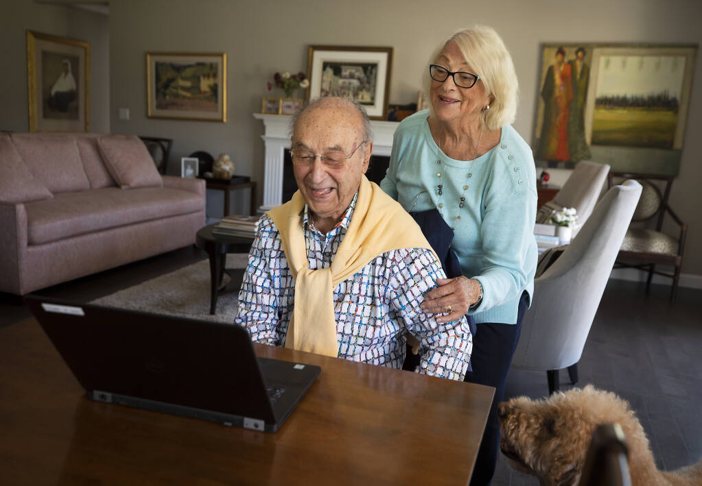 Dr. Norman Panting, 93, and his wife Karen look through old Press Democrat articles from the late 1950s highlighting his efforts to convince Sonoma County residents to get their polio vaccinations in the late 1950s. (Photo by John Burgess/The Press Democrat)