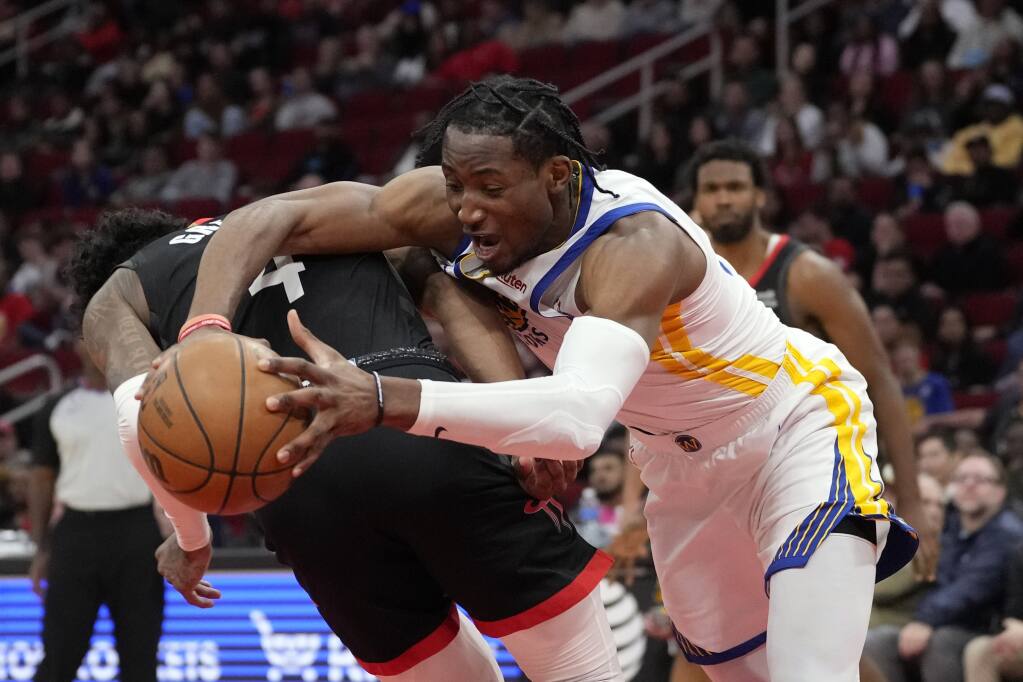 Golden State Warriors' Jonathan Kuminga, right, is fouled by Houston Rockets' Jalen Green (4) during the second half of an NBA basketball game Monday, March 20, 2023, in Houston. The Warriors won 121-108. (AP Photo/David J. Phillip)