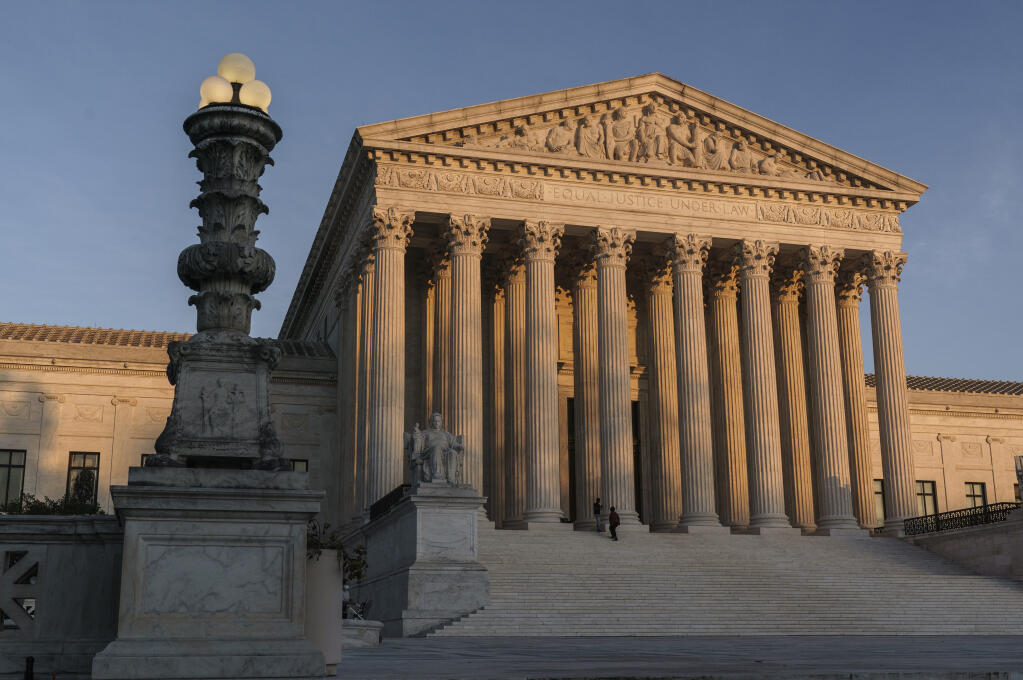 FILE - In this Nov. 6, 2020, file photo the Supreme Court is seen as sundown in Washington. The Supreme Court rejected on Dec. 11,a lawsuit backed by President Donald Trump to overturn Joe Biden’s election victory, ending a desperate attempt to get legal issues rejected by state and federal judges before the nation’s highest court. (AP Photo/J. Scott Applewhite, File)