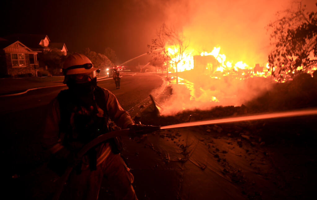 Houses burn on Mountain Hawk Drive in Santa Rosa's Skyhawk Community as the Shady fire rolls in from Napa County, Monday morning, Sept. 28, 2020. (Kent Porter / The Press Democrat)
