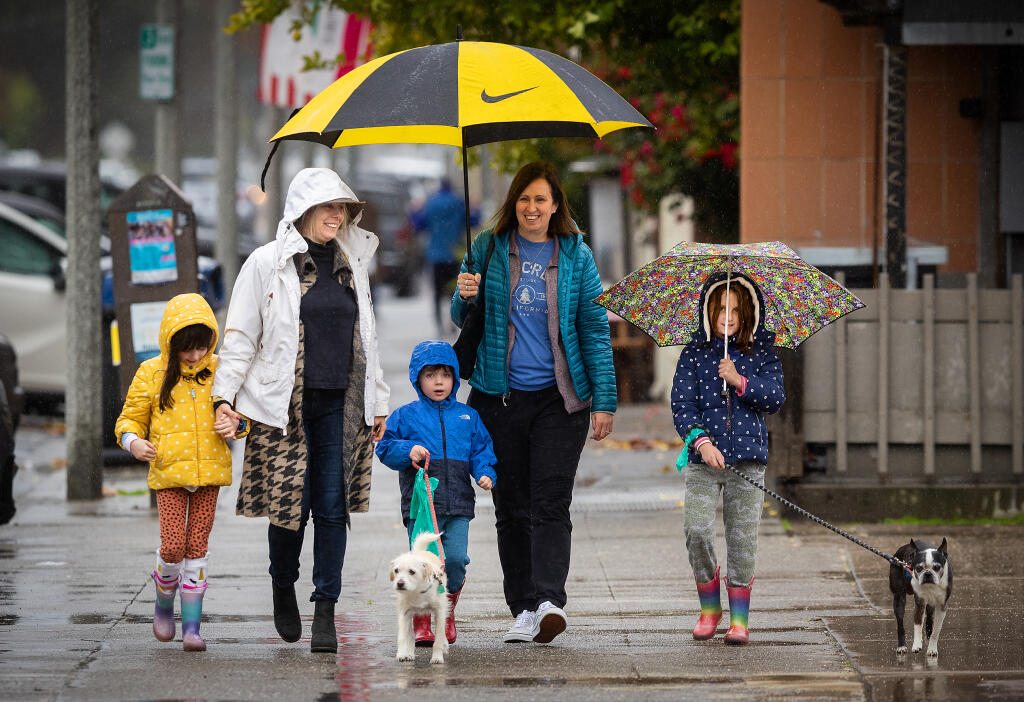 From left, Ryan, 6, Nicole, Ronan, 3, Kara and Tatum, 6, Ahlgren-Formanek, of Pleasant Hill, geared up for the wet weather on a day outing to the Sonoma Plaza Monday, January 2, 2023.   In spite of the cold, their destination was an ice cream shop they remembered from a previous visit. (John Burgess/The Press Democrat)