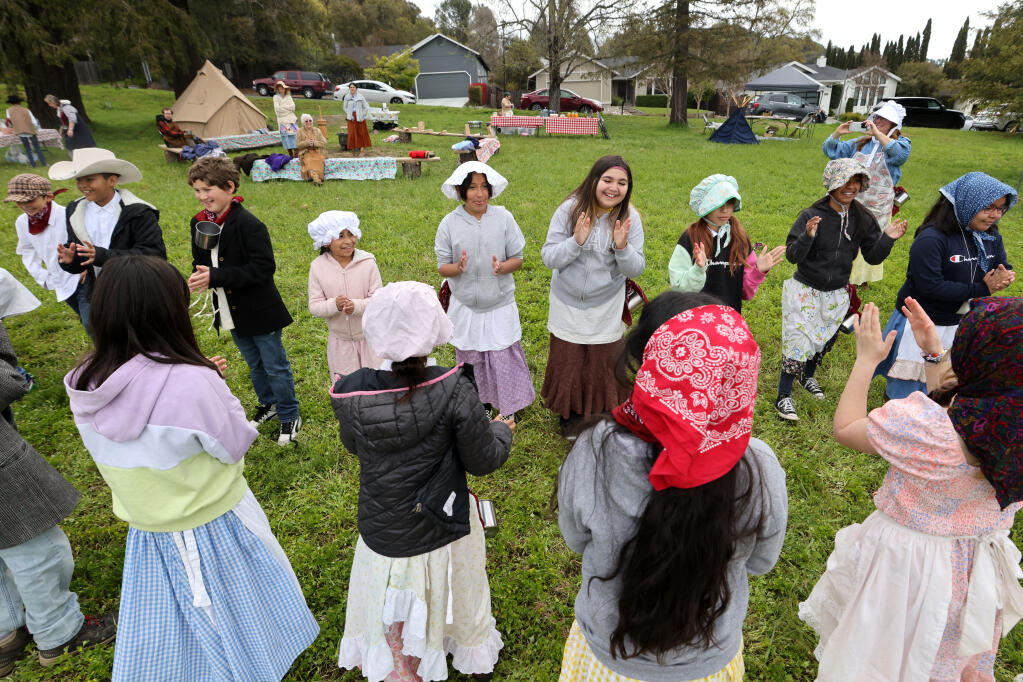 Fourth graders from Healdsburg Elementary Fitch Mountain Campus learn how to square dance during a Pioneer Day Camp at the school in Healdsburg, Thursday, April 6, 2023. (Beth Schlanker/The Press Democrat)