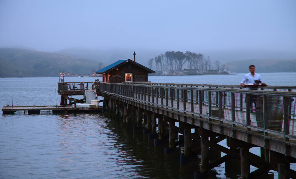 Nick’s Cove Restaurant & Cottages features a 400-foot-long pier with a rustic fishing shack at the end that serves as a private dining room. Hog Island is in the background. (Frankie Frankeny/Cameron + Company)