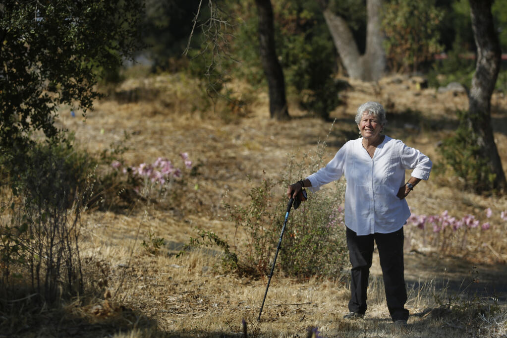 Carol Eber, a descendant of Mark and Guadalupe West, visits the West family grave site from the 1800s where cadaver dogs have recently located the scent of human remains. Photo taken near Redwood Adventist Academy in Santa Rosa on Monday, Aug. 16, 2021. (Beth Schlanker/The Press Democrat)