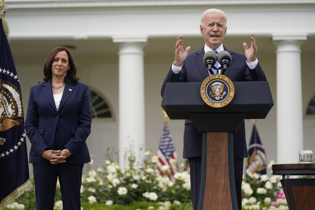 Vice President Kamala Harris listens as President Joe Biden speaks on updated guidance on face mask mandates and COVID-19 response, in the Rose Garden of the White House, Thursday, May 13, 2021, in Washington. (AP Photo/Evan Vucci)
