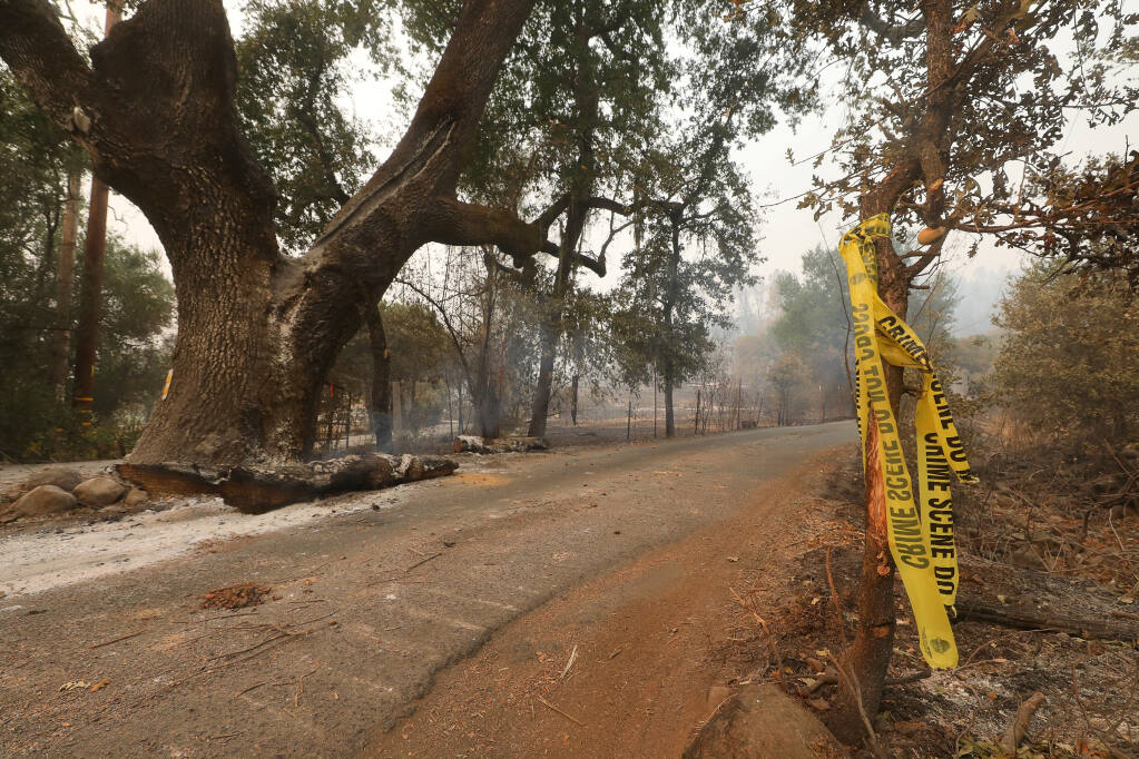 Crime scene tape marks an area along North Fork Crystal Springs Road where investigators have been looking into the cause of the Glass incident fire near Deer Park on Thursday, October 1, 2020. (Christopher Chung/ The Press Democrat)