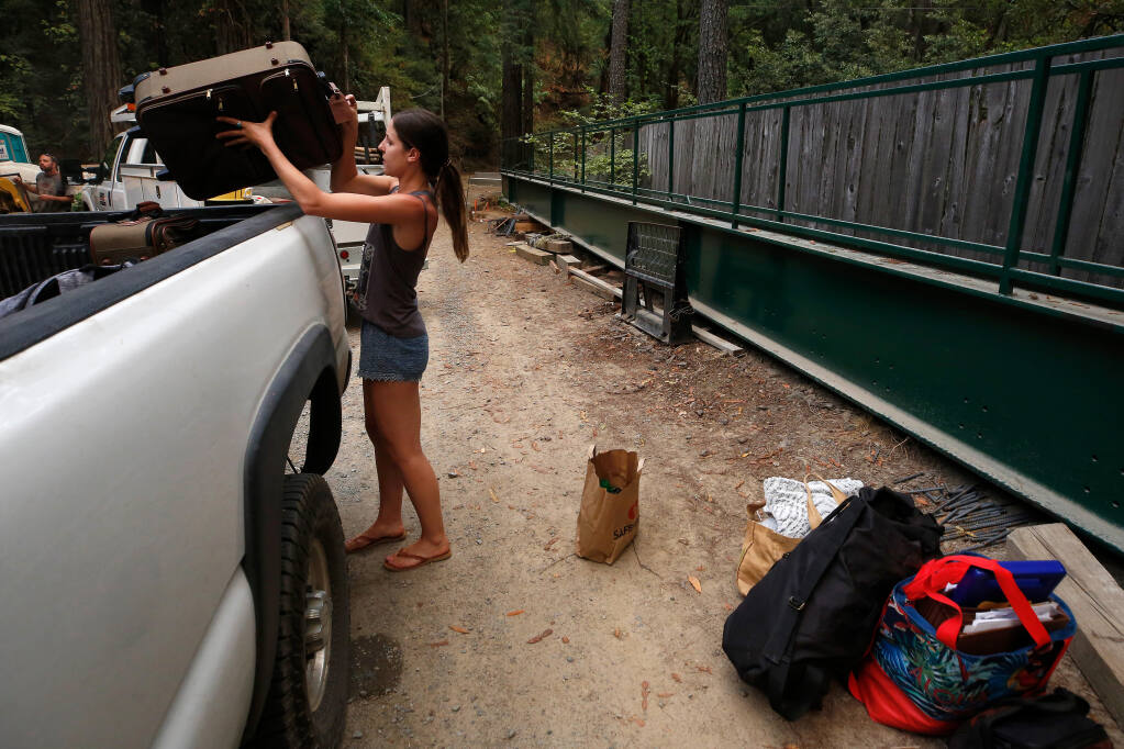 Milan Spadoni places her belongings in a truck, following mandatory evacuation orders for her neighborhood on Palmer Creek Road as the 13-4 fire, now known as the Walbridge fire, approaches her area west of Healdsburg on Tuesday, Aug. 18, 2020. (Alvin A.H. Jornada / The Press Democrat)