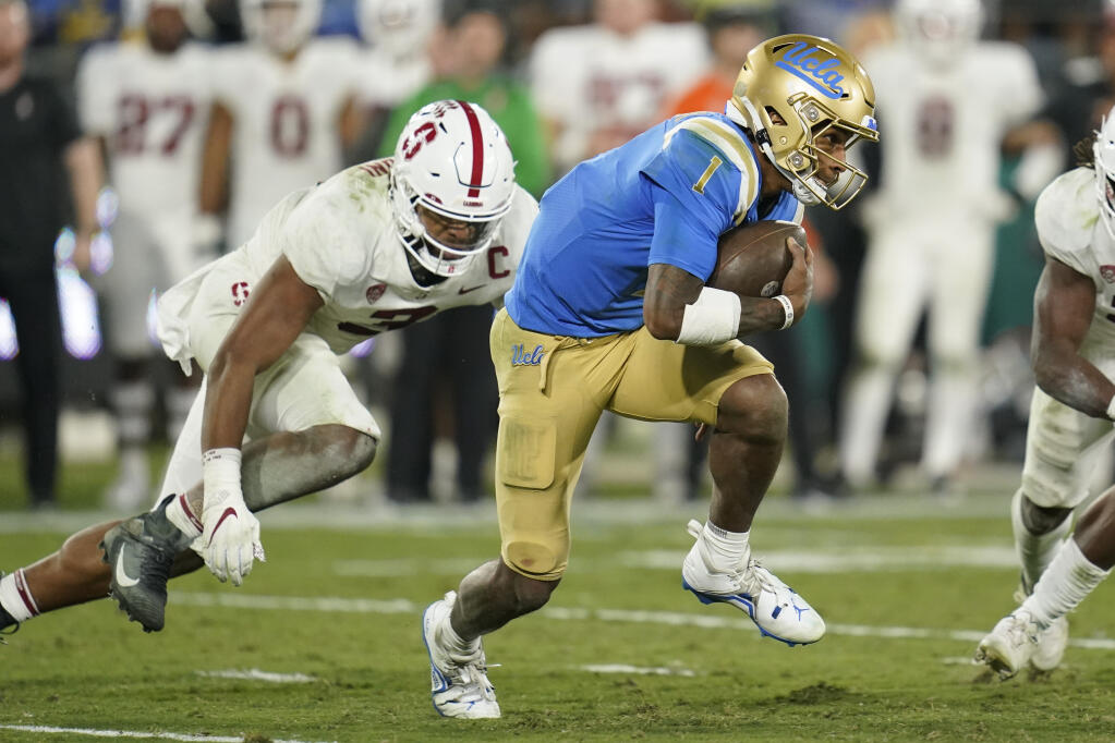 UCLA quarterback Dorian Thompson-Robinson is tackled by Stanford linebacker Levani Damuni (3) during the second half Saturday, Oct. 29, 2022, in Pasadena. (Ashley Landis / ASSOCIATED PRESS)