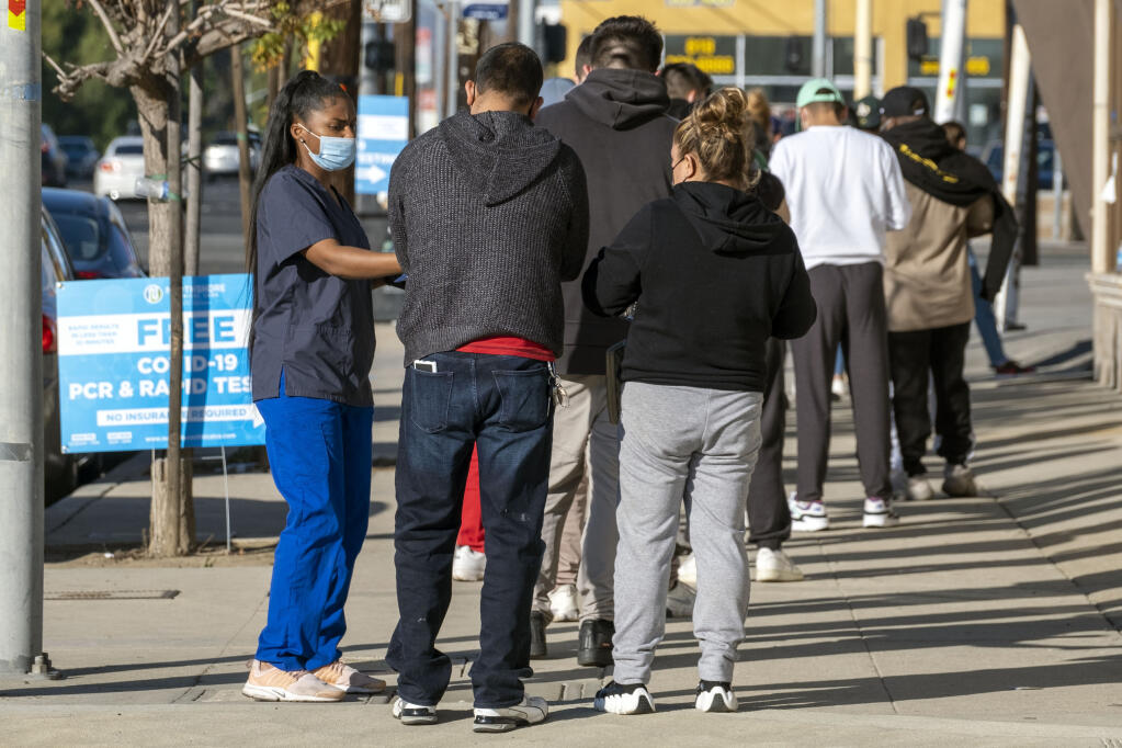 People wait in line to be tested for the COVID-19 virus at a testing site on Balboa Blvd and Saticoy St in Van Nuys, Tuesday, Jan 4, 2022. (Hans Gutknecht/The Orange County Register via AP)
