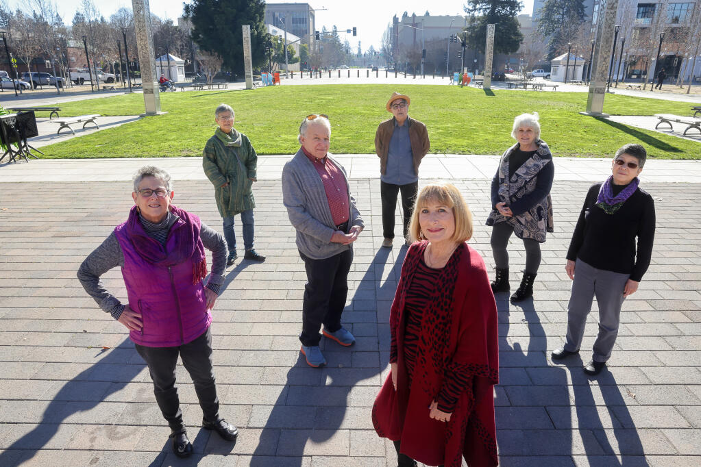 Nina Bonos, left, Sachiko Knappman, Asher Sheppard, Gary Sugiyama, Gael Forest-Knowles, Becky Sugiyama, and Phyllis Tajii pose for a photo at the site of the proposed Unum Sculpture at Old Courthouse Square in Santa Rosa. The group objects to the exclusion of the Hebrew and Japanese languages from the sculpture, which will include 17 other languages.  (Christopher Chung/ The Press Democrat)