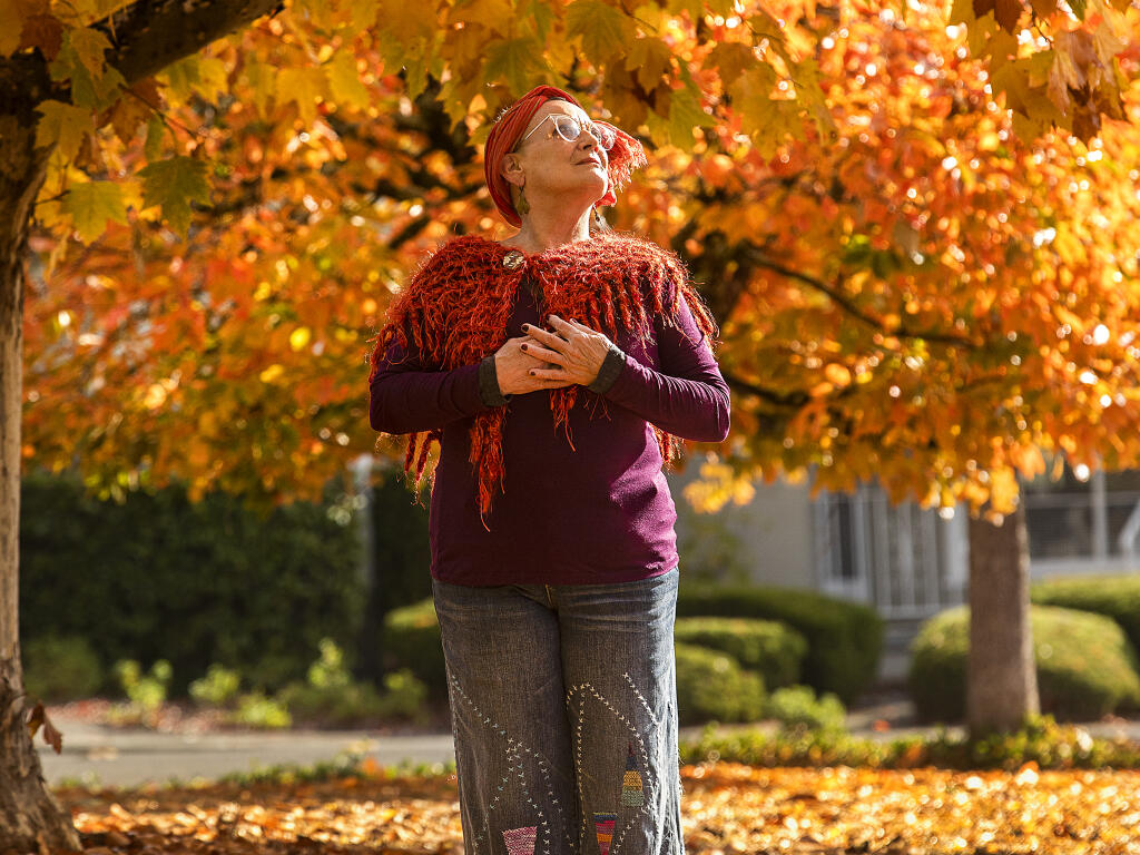 Diana Rose is grateful she can still take a stroll along Jewell Drive in Santa Rosa where she grew up in the 1950s. Some of the trees in the neighborhood were planted when she was young, but now she is grateful for their fall colors. (John Burgess/The Press Democrat)
