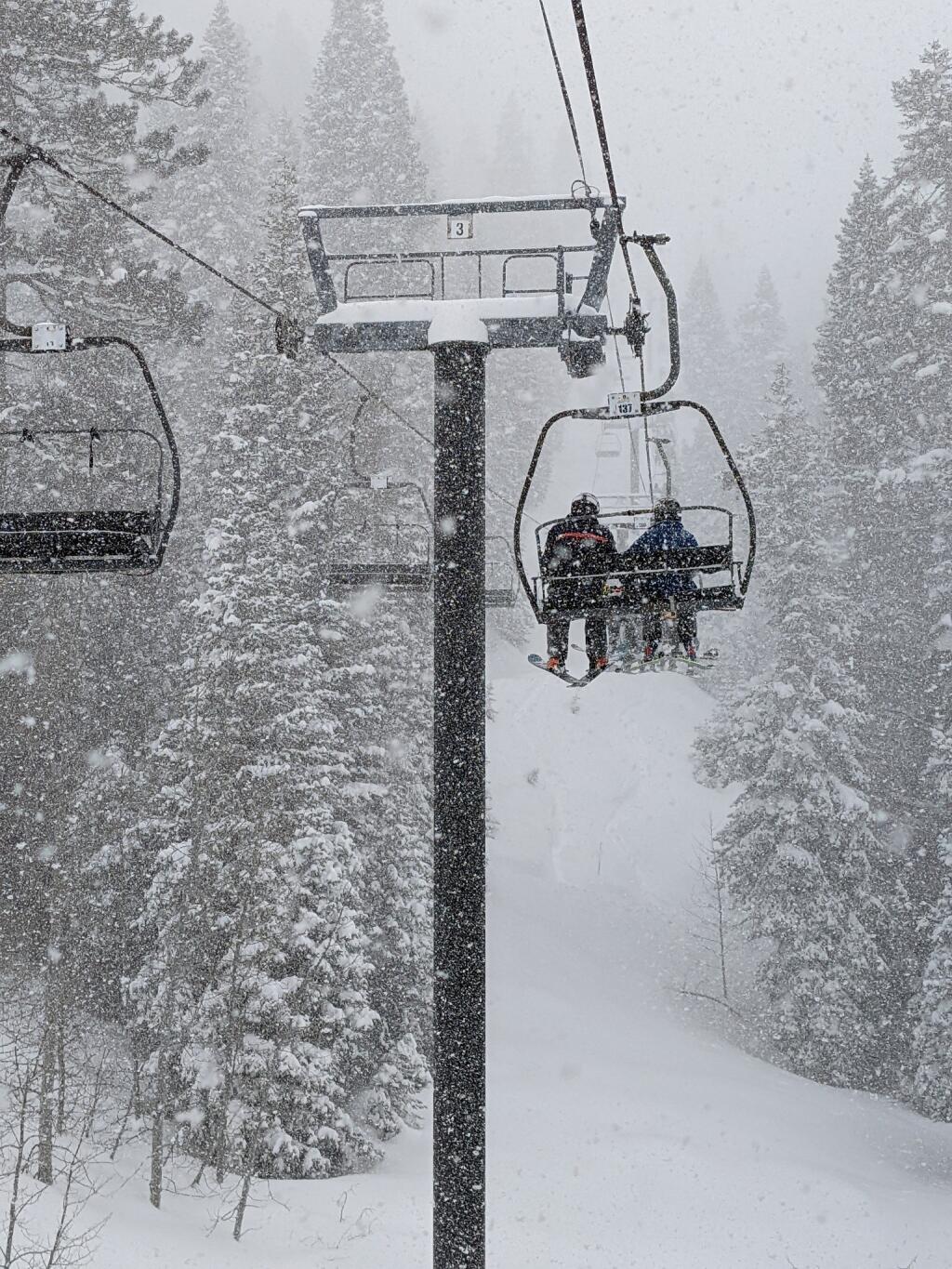 Skiers ride ski lifts at Palisades Tahoe, Feb. 25. (Tobias Toernqvist)