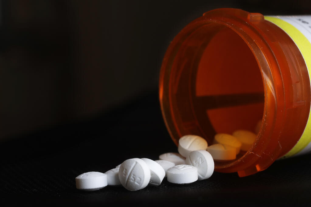 FILE - This Aug. 29, 2018, file photo shows an arrangement of Oxycodone pills in New York. A $26 billion settlement between the three biggest U.S. drug distribution companies and drugmaker Johnson & Johnson and thousands of states and municipalities that sued over the toll of the opioid crisis is certainly significant, but it is far from tying a neat bow on the tangle of still unresolved lawsuits surrounding the epidemic. (AP Photo/Mark Lennihan, File)