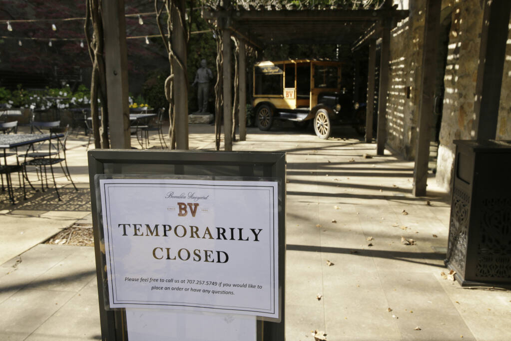 In this photo taken Thursday, March 19, 2020, a temporarily closed sign is posted outside the entrance to the Georges De Latour Reserve Tasting Room at the Beaulieu Vineyard winery in Rutherford. Wineries in the Napa Valley were closed due to coronavirus restrictions for weeks or months at a time in 2020 and 2021, and many vintners shifted to curbside pick-up, online orders and virtual tastings to maintain consumer connections and eke out sales. (AP Photo/Eric Risberg)