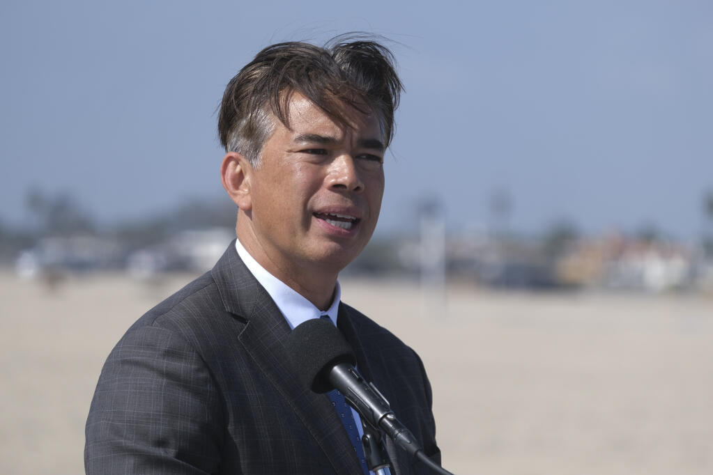 California Attorney General Rob Bonta answers questions in a news conference on a beach in Huntington Beach, Calif., Monday, Oct. 11, 2021. (AP Photo/Ringo H.W. Chiu)