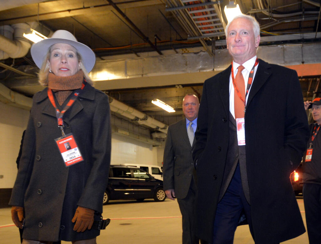 FILE - In this Nov. 30, 2015, file photo, Cleveland Browns owner Jimmy Haslam, right, and his wife Dee Haslam walk to the playing field before an NFL football game against the Baltimore Ravens in Cleveland. Browns owners Dee and Jimmy Haslam will stand in support of quarterback Baker Mayfield and any other Cleveland players who kneel during the national anthem this season. (AP Photo/David Richard, File)