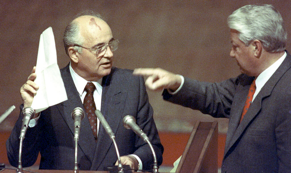 FILE - Soviet President Mikhail Gorbachev, left, holds notes given to him by Russian President Boris Yeltsin, right, during a special session of the Russian Federation Parliament in Moscow on Friday, August 23, 1991. Russian news agencies are reporting that former Soviet President Mikhail Gorbachev has died at 91. The Tass, RIA Novosti and Interfax news agencies cited the Central Clinical Hospital. (AP Photo/Boris Yurchenko, File)
