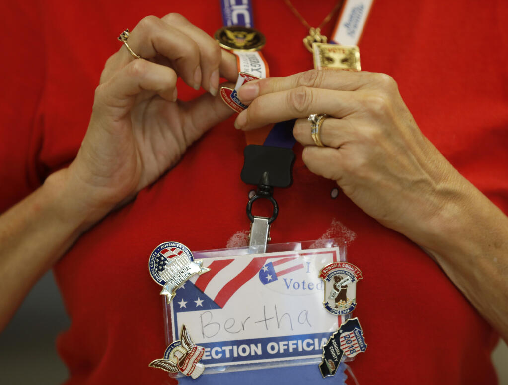 Election clerk Bertha adds a new pin to her collection of Sonoma County election pins at the voting center at the Veterans Memorial Building in Santa Rosa, Calif., on Wednesday, June 1, 2022. (BETH SCHLANKER/ The Press Democrat)