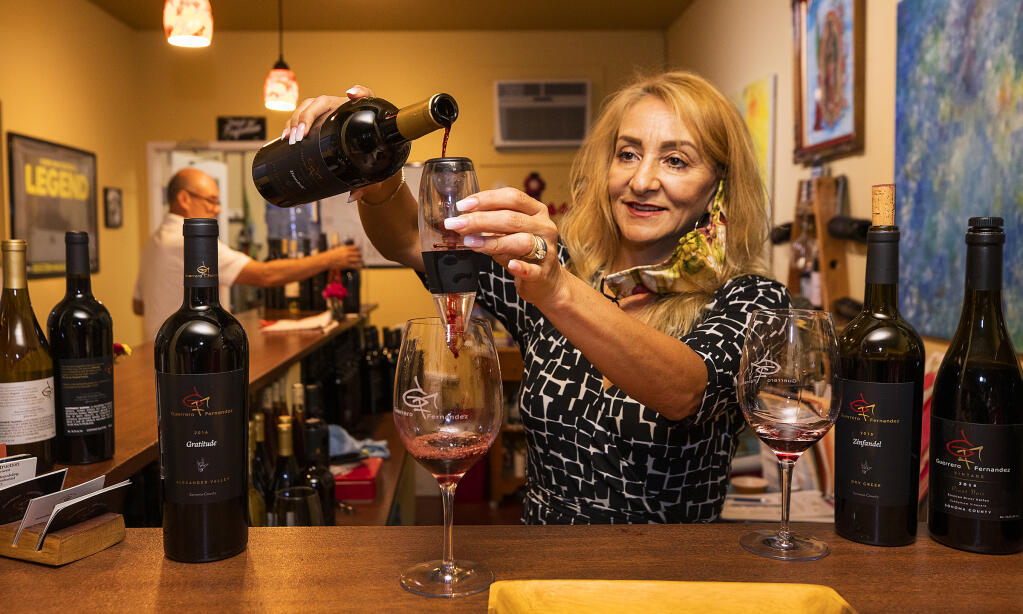 Olga Fernandez pours a sample of their wines for customers at Guerrero Fernandez Winery in Windsor on Friday, August 27, 2021.  (Photo by John Burgess/The Press Democrat)s