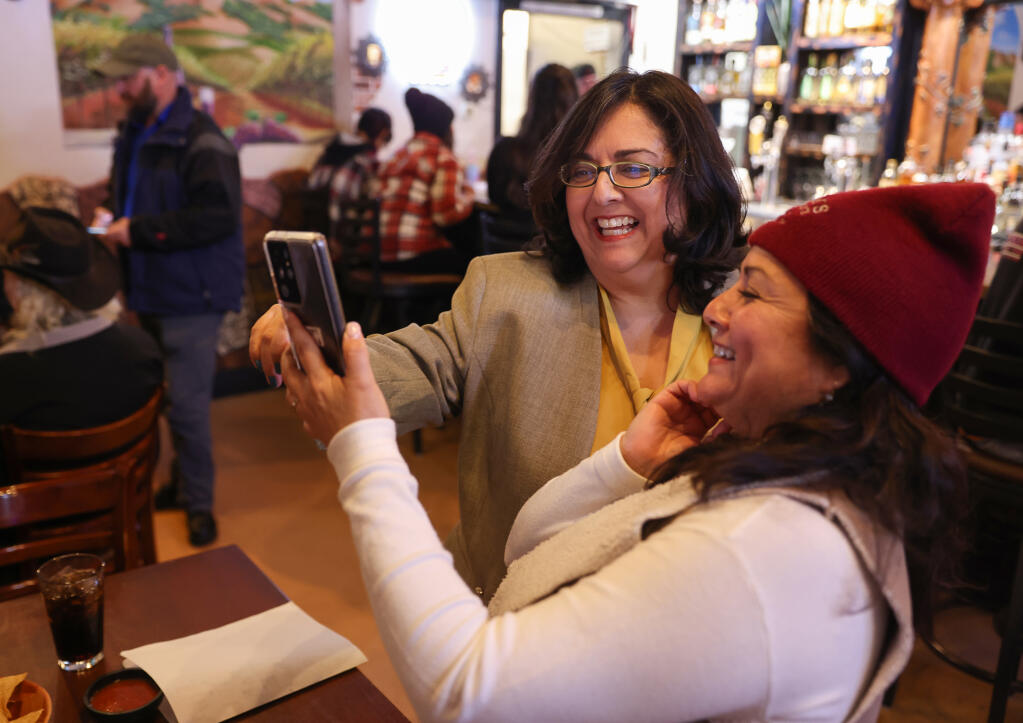 Windsor’s new Mayor Rosa Reynoza, left, won her seat during the Nov. 8 general election, becoming the town’s first Latina elected to the post. Here she checks election results with Cyndi Nunez during her election watch party at Lupe’s Diner in Windsor, Tuesday, Nov. 8, 2022. (Christopher Chung/The Press Democrat file)