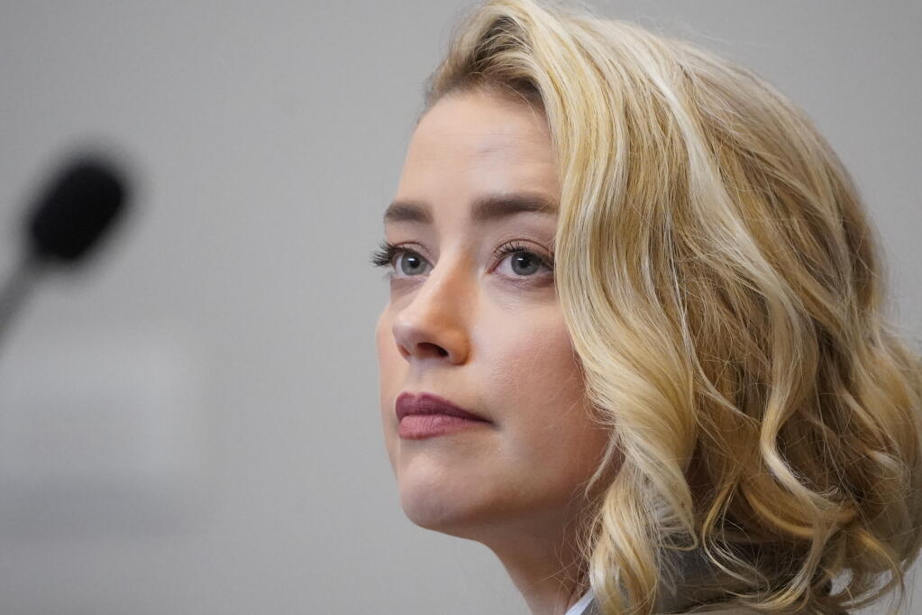 Actor Amber Heard listens in the courtroom at the Fairfax County Circuit Courthouse in Fairfax, Va., Monday, May 23, 2022. Actor Johnny Depp sued his ex-wife Amber Heard for libel in Fairfax County Circuit Court after she wrote an op-ed piece in The Washington Post in 2018 referring to herself as a "public figure representing domestic abuse." (AP Photo/Steve Helber, Pool)