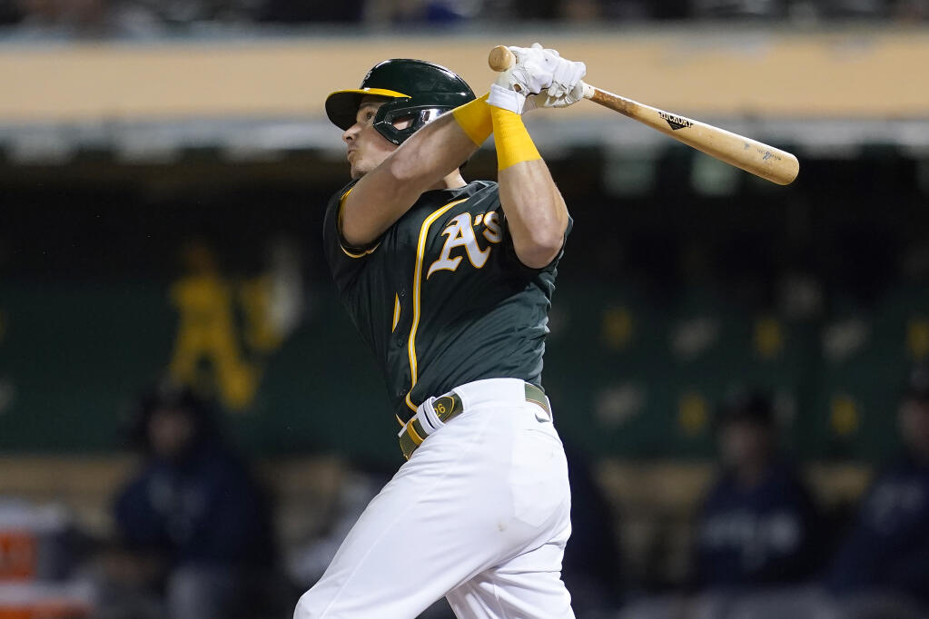 Oakland Athletics' Matt Chapman hits a home run against the Seattle Mariners during the fifth inning of a baseball game in Oakland, Calif., Wednesday, Sept. 22, 2021. (AP Photo/Jeff Chiu)