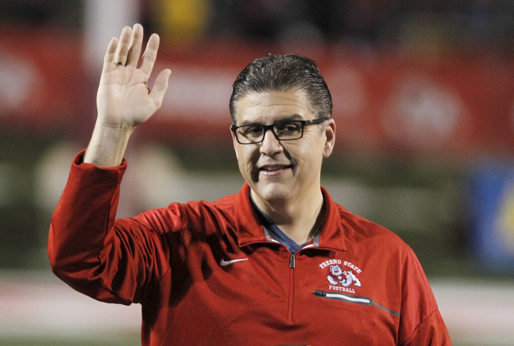 FILE - Joseph I. Castro, at the time president of Fresno State, waves to the crowd before the team's NCAA college football game Nov. 4, 2017, against BYU in Fresno, Calif. Castro has resigned as chancellor of California State University after accusations that he mishandled sexual misconduct allegations. The CSU Board of Trustees says Castro resigned Thursday, Feb. 17, 2022, effective immediately. (AP Photo/Gary Kazanjian, File)