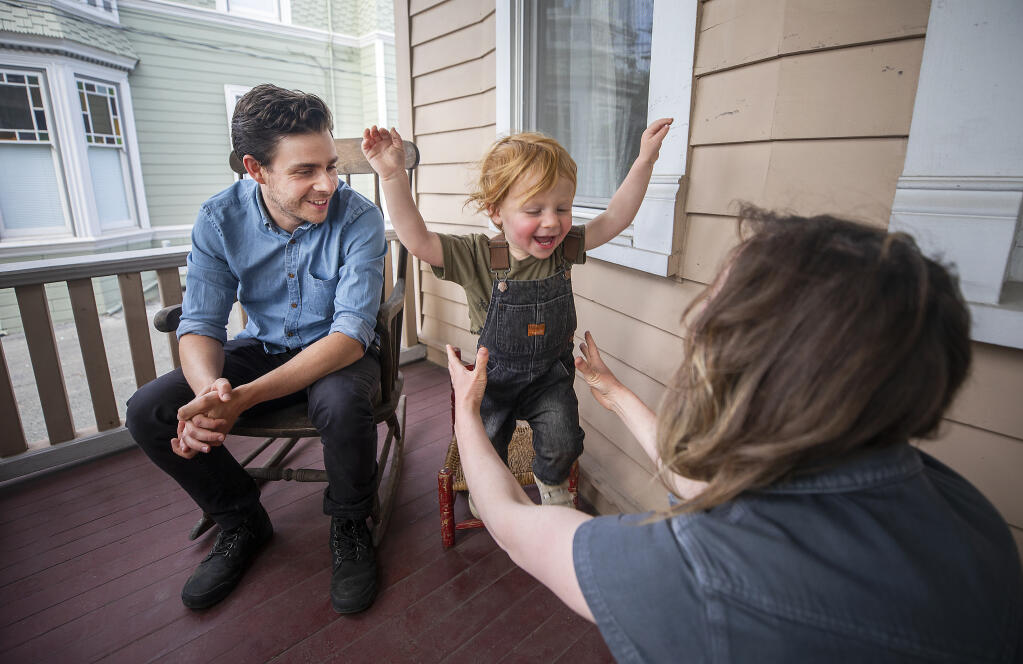 Ariel and David Beauhaire play with their son Akiva, 22 months, the front porch of their Petaluma rental home on Friday, June 11, 2021. The couple have made four recent offers on homes in west Petaluma and Penngrove to no avail. (John Burgess/The Press Democrat)