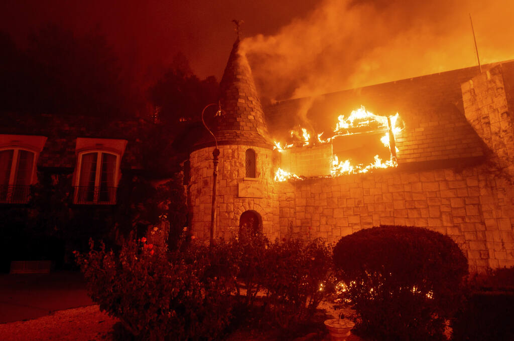 Flames from the Glass Fire consume Chateau Boswell Winery in St. Helena, Calif., Sunday, Sept. 27, 2020. (AP Photo/Noah Berger)