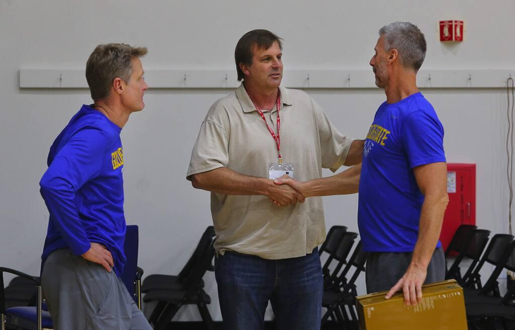 Golden State Warriors head coach Steve Kerr, left, SRJC head coach Craig McMillan and Warriors assistant coach Bruce Fraser talk after an interview in Oakland on Tuesday, Nov. 7, 2017. The three men were teammates at the University of Arizona. (Christopher Chung / The Press Democrat)