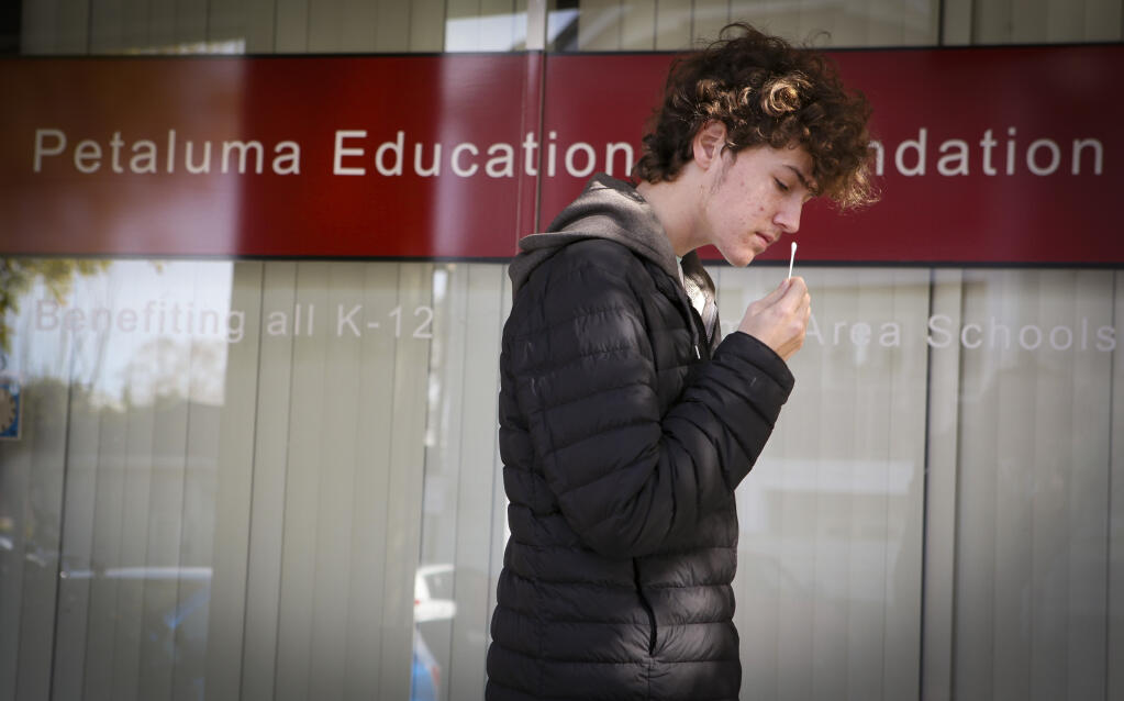 Harry Van Der Meer, a student at Petaluma High School, does a COVID-19 self-test at the district office Tuesday, Jan. 11, 2022. (CRISSY PASCUAL/ARGUS-COURIER STAFF)