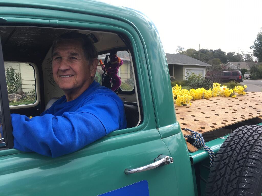 Merle Reuser, Sonoma County’s Johnny Appleseed of daffodils, during Monday’s door-to-door distribution in Santa Rosa. (Chris Smith/The Press Democrat)