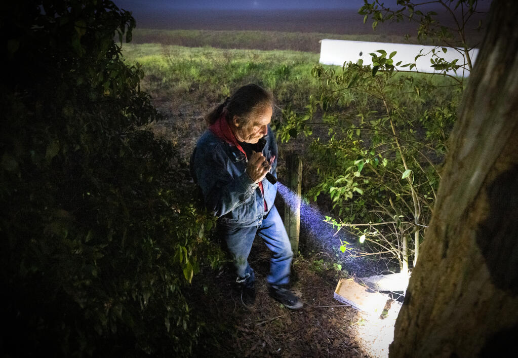 COTS resident and count volunteer Jeff O’Dell searches an area behind a Petaluma business park for signs of homeless camps early Friday, January 27, 2023. O’Dell was participating in the Sonoma County Point-in-Time Street Count for all populations the homeless.   (John Burgess/The Press Democrat)