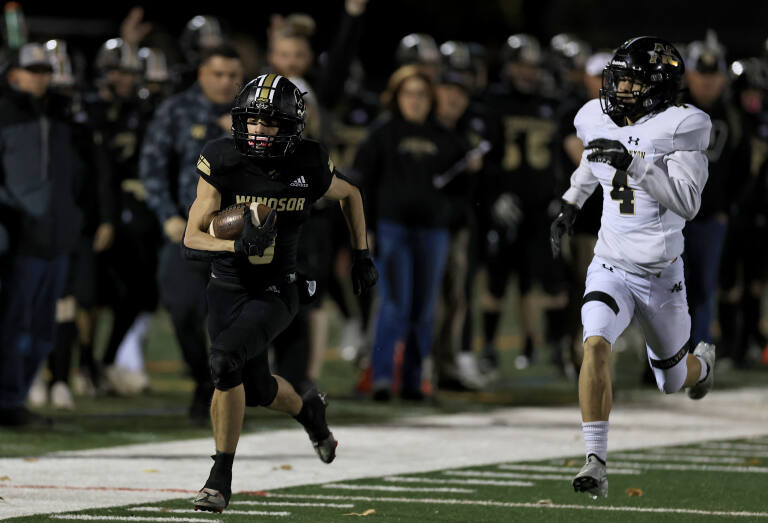 Gunnar Erickson of Windsor gets in front of American Canyon defender Isaiah Vaughan for a touchdown, during the Div. 3 semi-finals at Windsor High School, Friday, Nov. 18, 2022. (Kent Porter / The Press Democrat) 2022