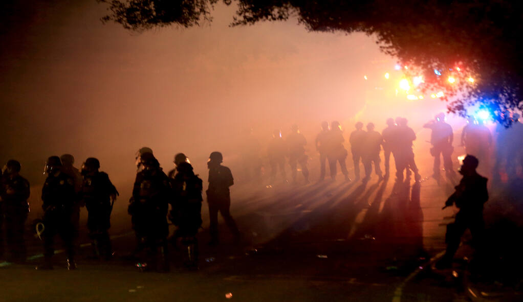 Tear gas hangs in the air after protesters faced off with the California Highway Patrol, Saturday, May 30, 2020 on the downtown offramp from south Highway 101 in Santa Rosa.  (Kent Porter / Press Democrat) 2020