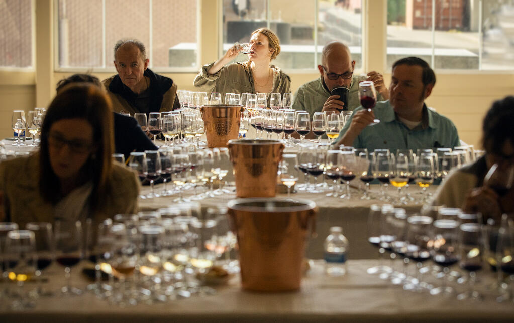 Maegan Lavelle, with LIOCO Wine Co., center, samples the finalists while judging the North Coast Wine Challenge in Santa Rosa, Wednesday, April 6, 2022. (John Burgess/The Press Democrat file)