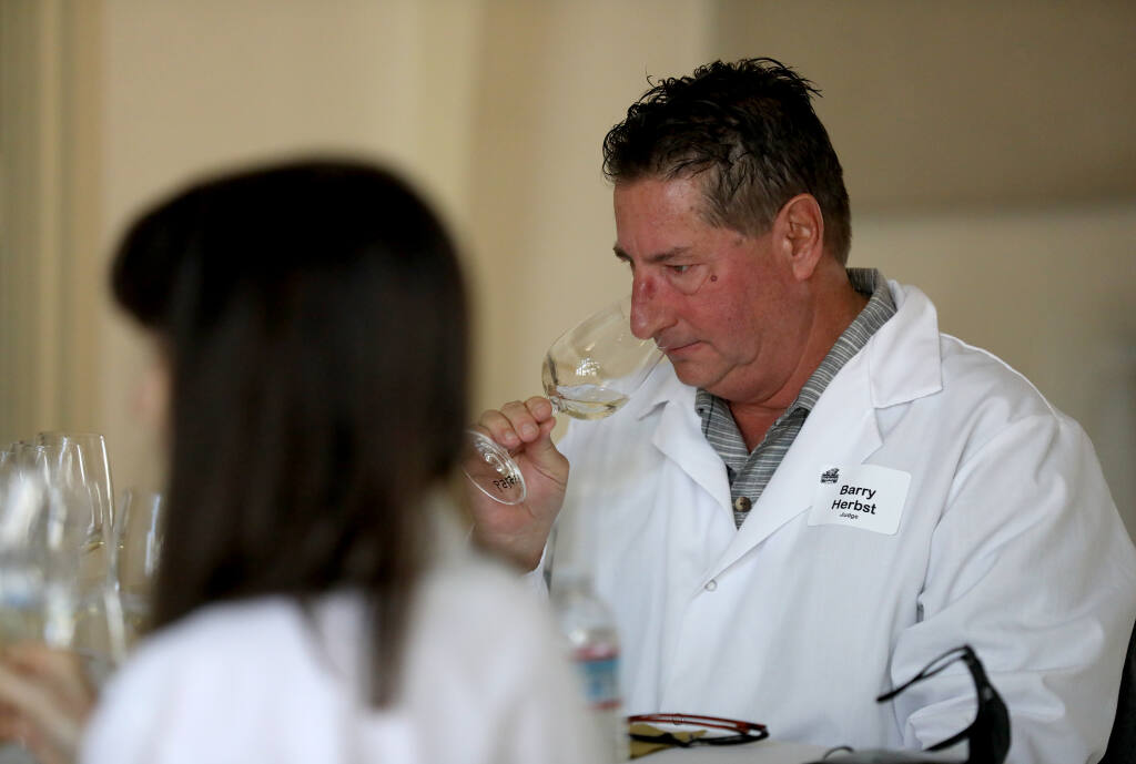 Judge Barry Herbst smells a glass of wine before tasting it during the Sonoma County Harvest Fair Wine Competition at the Sonoma County Fairgrounds in Santa Rosa, Calif., on Tuesday, September 15, 2020. (BETH SCHLANKER/ The Press Democrat)