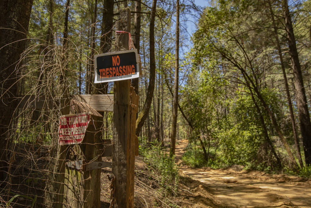 No trespassing signs hang at the entrance to Ken Bareilles, Felta Creek Road property, May 23, 2022. (Chad Surmick / The Press Democrat)