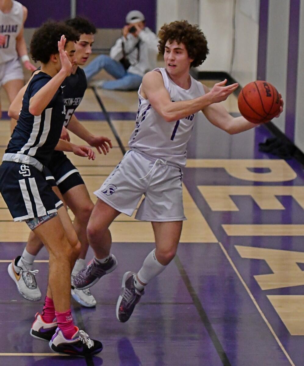 Petaluma’s Brody Loveless attempts to make a pass under strong pressure from Justin-Siena defenders during a game played on Jan. 20, 2023. (Sumner Fowler / For the Argus-Courier)