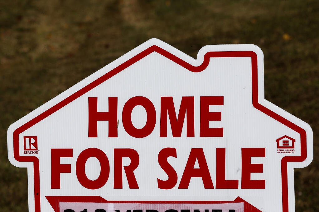 FILE - This Thursday, Oct. 17, 2019, file photo shows a home for sale sign in Orange County near Hillsborough, N.C. Zillow Group said Tuesday, Nov. 2, 2021, that it will stop buying and selling homes, citing the â€œunpredictabilityâ€ of forecasting housing prices. (AP Photo/Gerry Broome, File)