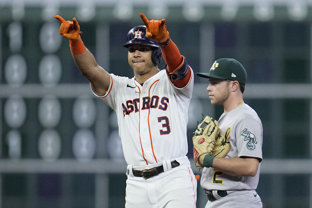 The Astros’ Jeremy Pena, left, celebrates next to Oakland Athletics second baseman Nick Allen after hitting an RBI double during the sixth inning Saturday, Aug. 13, 2022, in Houston. (Kevin M. Cox / ASSOCIATED PRESS)