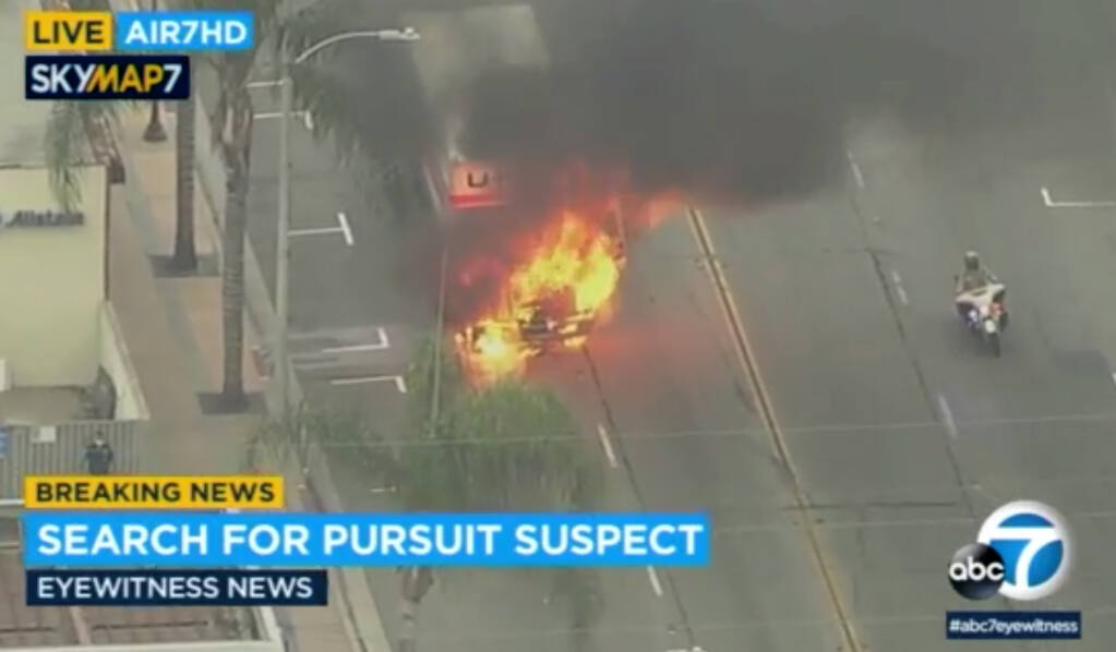 In this aerial image take from video provided by KABC-TV, shows a fully engulfed in fire a U-Haul truck after exiting a freeway in the Bellflower, Calif. an area of Los Angeles on Tuesday, May 11, 2021. A reportedly stolen U-Haul truck towing a trailer was pursued on Southern California freeways early Tuesday until it burst into flame and the driver unsuccessfully tried to run away. (KABC-TV via AP)